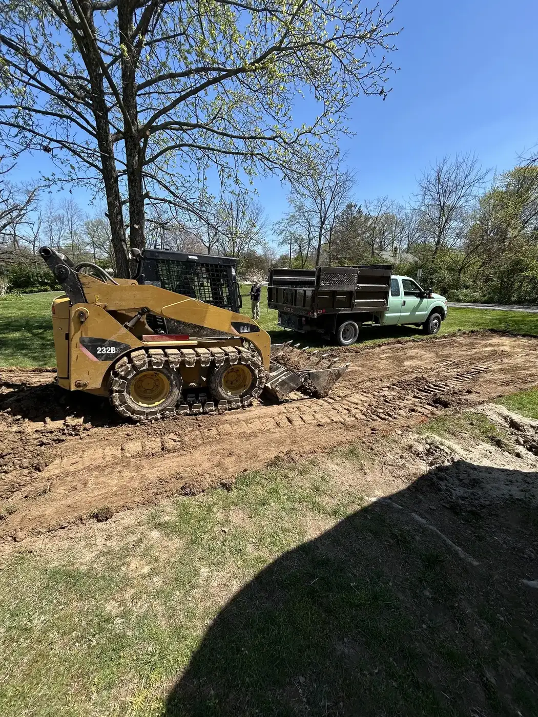 Phelps skid steer grading soil for site preparation