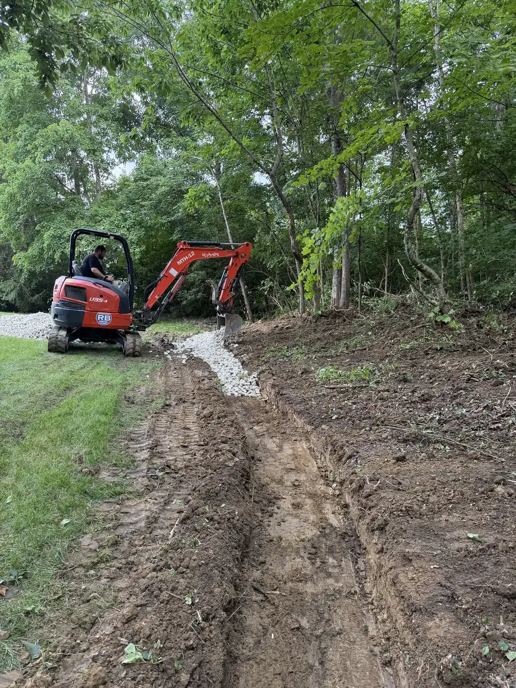 Phelps mini excavator trenching for a yard drainage correction
