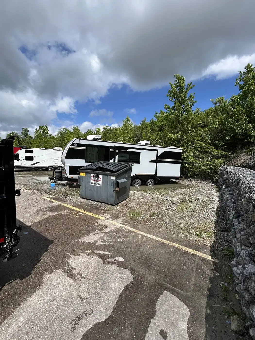 Phelps dumpster placed at an RV lot for a cleanup project