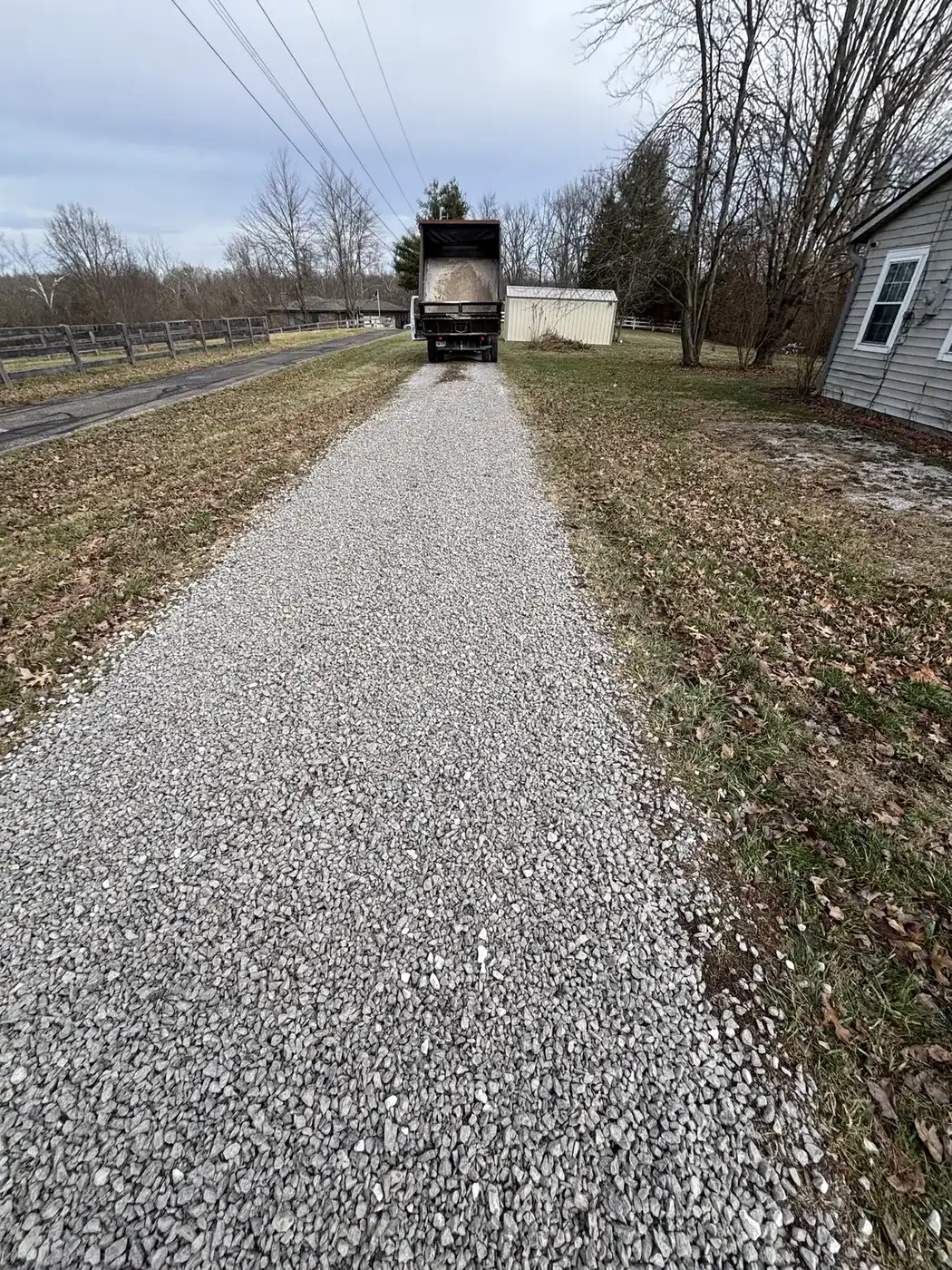 Long gravel driveway graded and topped by Phelps