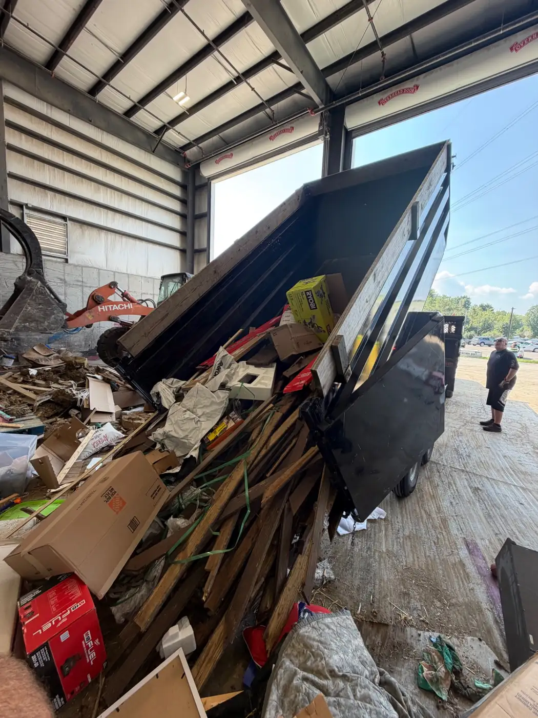 Phelps dump trailer emptying lumber and renovation debris at a transfer station