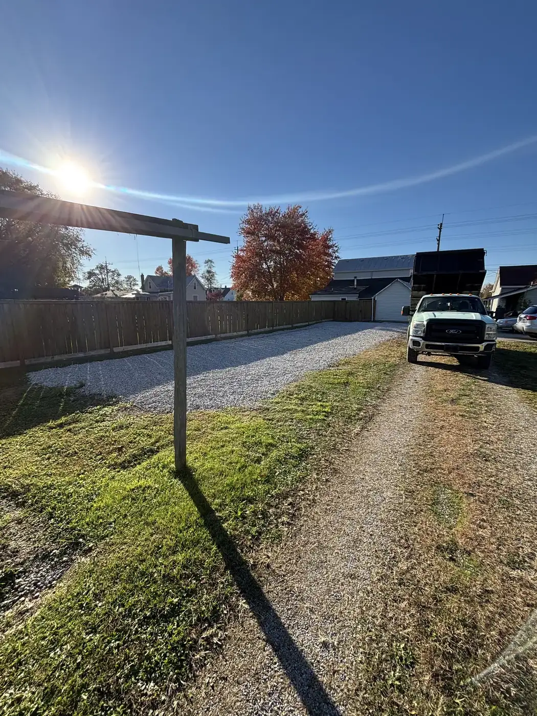 Gravel driveway repaired by Phelps with the company truck on site